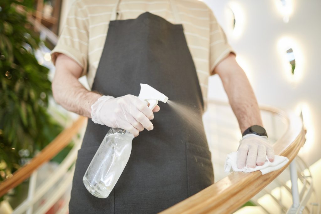 Man Sanitizing Stairs Close Up